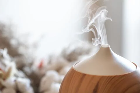 Modern oil aroma diffuser close up on a blurred background. Stock Photos