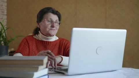 Modern old age, elderly pretty woman undergoes online training use video calling Stock Footage 131501195