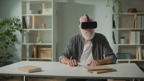 A Modern Old Man in VR Glasses Examines Everything Around. Video stock 244962048