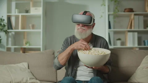 A Modern Old Man in VR Glasses Examines Everything Around. Stock Footage 250304738