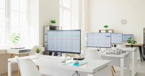 Modern open office with desktop monitors showing spreadsheet data for analysis Stock-Footage 342659331
