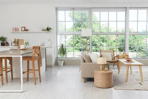Modern open plan apartment interior with kitchen island, living room sofa, an Stock Photos