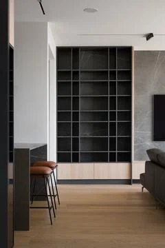 Modern open-plan interior with custom bookshelf and kitchen island Stock Photos