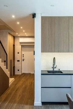 Modern open plan kitchen and hallway interior with staircase Fotos de archivo