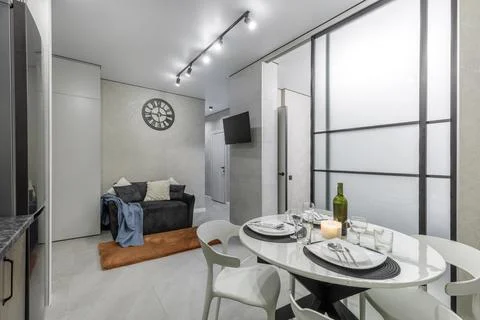 Modern Open Plan Studio with Dining Table and Kitchen Stock Photos