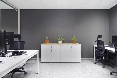 Modern open space office with computer monitors on white desks Stock Photos