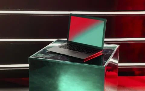 Modern opened laptop computer on creative designer metallic shiny cube with Foto stock