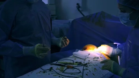 In a modern operating room, a group of young doctors during Stock Footage 270553379