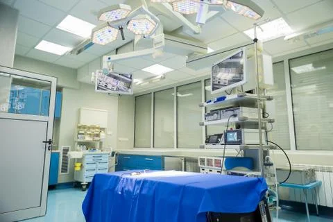 Modern operating room with surgery table, effective lights and life support s Stock Photos