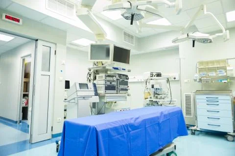 Modern operating room with surgery table, effective lights and life support s Stock Photos
