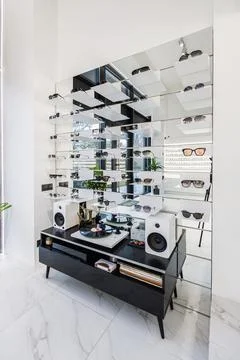 Modern Optical Store Interior with Mirrored Display and Vinyl Record Player Stock Photos