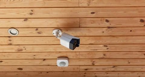 Modern Outdoor CCTV Camera on a Ceiling. Concept of Surveillance and Monitoring Stock Photos