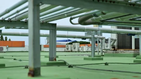 Modern outdoor cooling system featuring condenser coils, refrigerant piping and  Stock-Footage 347143882