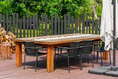 Modern outdoor dining table and chairs on backyard patio terrace, place to .. Stock Photos