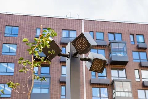 Modern outdoor lighting complex with multiple LED luminaires on single pole Stock Photos