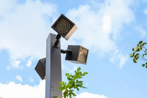 Modern outdoor lighting complex with multiple LED luminaires on single pole Stock Photos