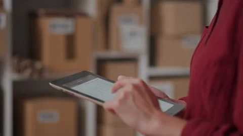 Modern packaging business. Warehouse worker tensely holding an electronic sc Stock Footage 234430226