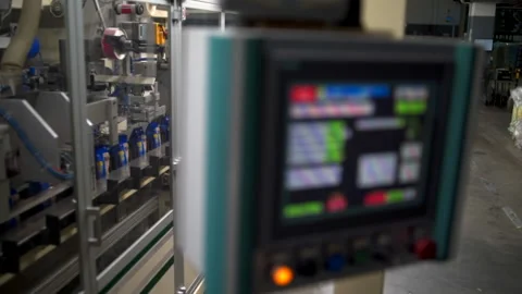Modern packing line of bulk goods behind control panel of mechanism Stock Footage 148947391