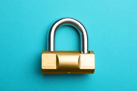 Modern padlock on light blue background, top view Foto stock