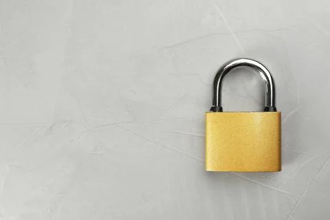 Modern padlock on light grey table, top view. Space for text Foto stock