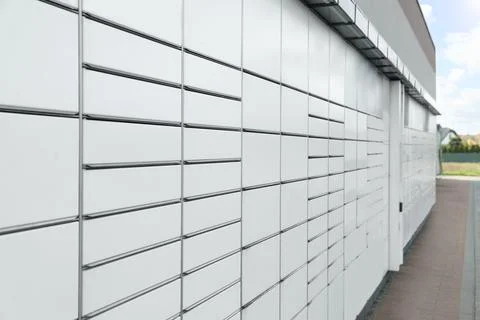 Modern parcel locker with many postal boxes outdoors Stock Photos