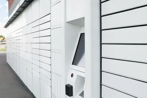 Modern parcel locker with many postal boxes outdoors Foto stock
