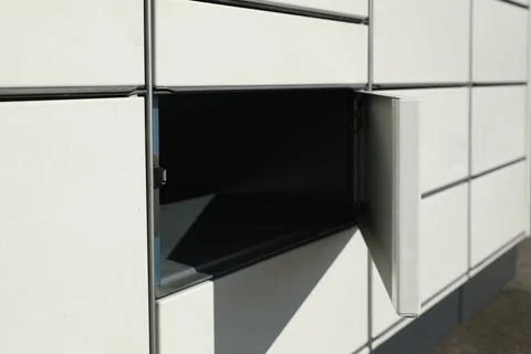 Modern parcel locker with open box, closeup view Foto stock
