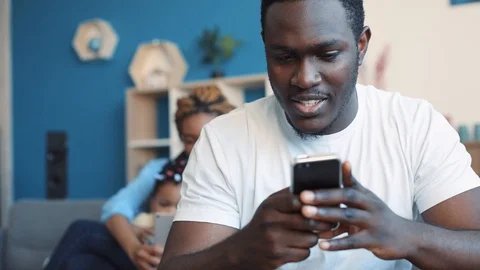 Modern parents spend their time with daughter, and surf the internet via the Stock-Footage 87256165