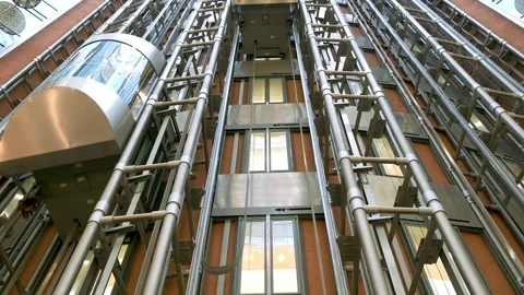 Modern passenger elevator made of metal, glass walls and panoramic views in a Stock Footage 288989545