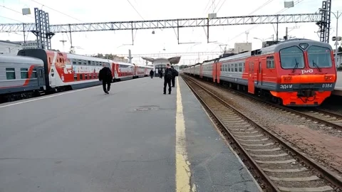 Modern passenger train is standing and on the right is a suburban old train Stock Footage 312263466