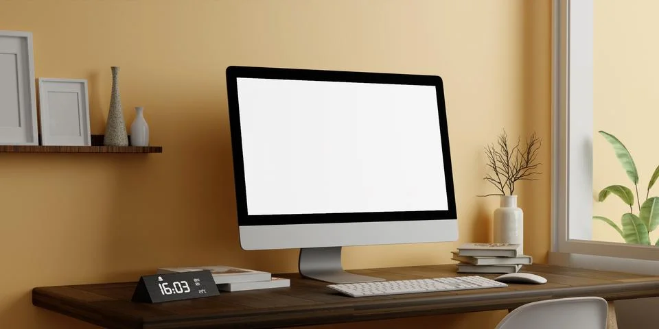 A modern PC computer blank screen mockup is on a table in a modern minimal home Stock Photos