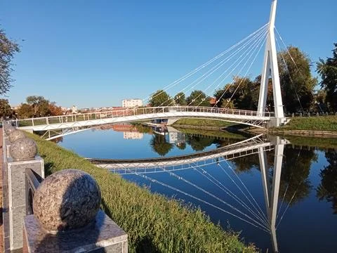 Modern pedestrian bridge with river reflection Stock Photos