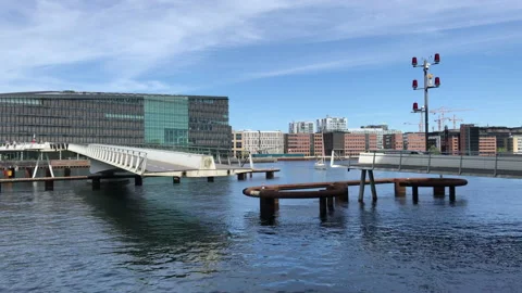 Modern pedestrian swing bridge opening in urban harbor Stock Footage 202165599