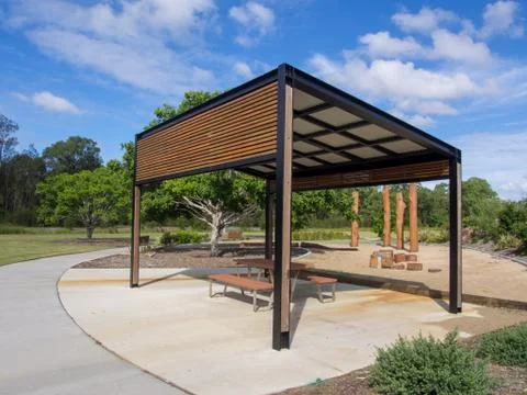 Modern pergola and sitting area with play ground behind in Public Park Stock Photos