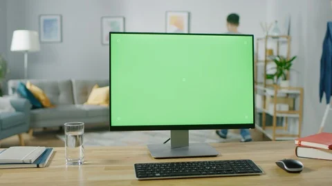 Modern Personal Computer with Green Mock-up Screen Display Standing on the Desk. Stock Footage 94956064