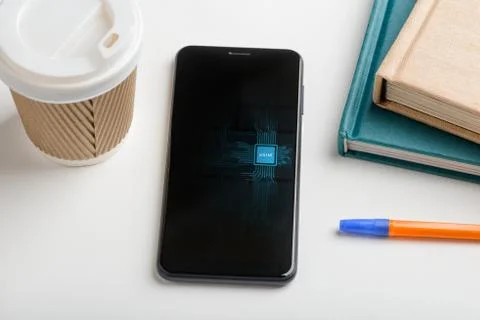 Modern phone with embedded SIM. Gadget laying on a table Stock Photos