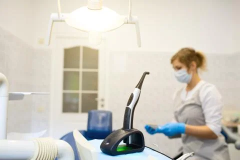 A modern photopolymerization lamp for light fillings in the dental office, on Stock Photos