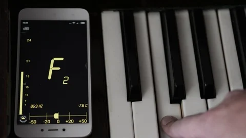 Modern piano tuning with the help of the program on the phone. Stock Footage 91792532