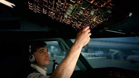 Modern plane or aircraft at the airport runway. The close shot of first pilot's Stock Footage 77334961