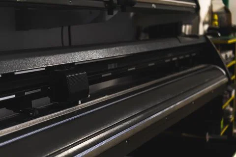 Modern plotter laser cutter machine in print house industry, close-up view ph Stock Photos