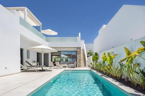 Modern Poolside with White Architecture Stock Photos