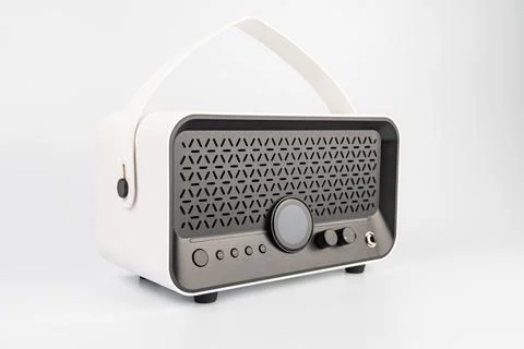 Modern portable Bluetooth speaker, white in color, compact and textured, wi.. Stock Photos