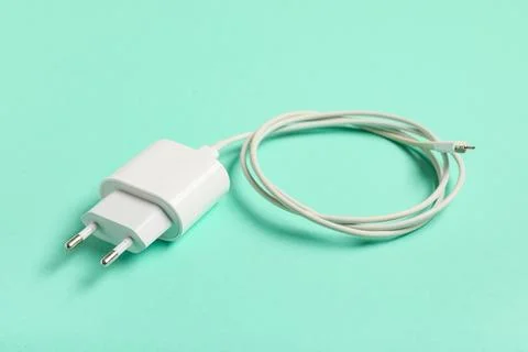 Modern power adapter and type-c cable on turquoise background, closeup Stock Photos