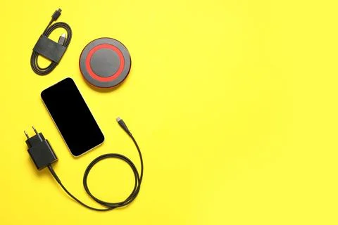 Modern power adapter, type-c USB cable, wireless charging pad and blank mobil Stock Photos