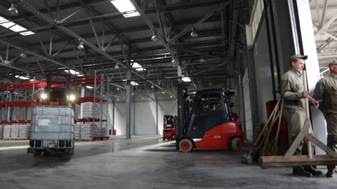 Modern Powerful Forklift with White Plastic Cube Drives out Vídeos de archivo 77534296