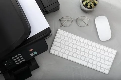 Modern printer, computer keyboard and mouse on grey table, flat lay Stock Photos