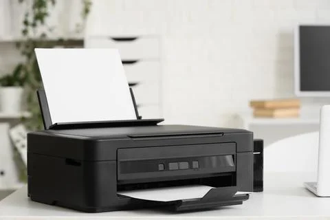 Modern printer on desk in office Stock Photos
