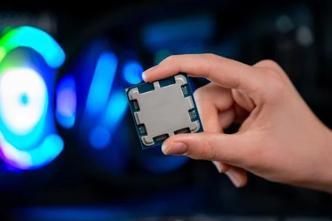 Modern processor chip held in hand inside desktop pc, highlighting computin.. Stock Photos