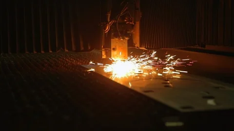 Modern programmed robot head cuts metal with sparks. Stock Footage 104023119