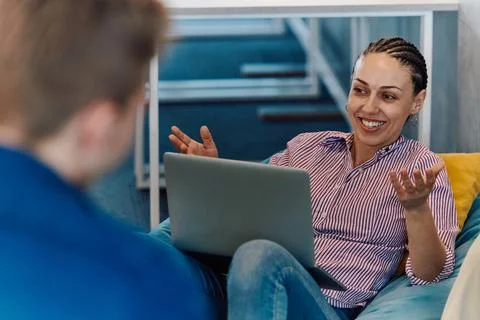 A modern programmer discussing future business projects with colleagues in a Foto stock